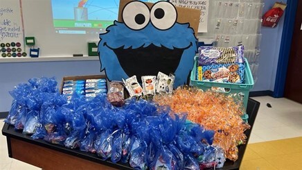 Table dressed for a school event with party bags and merchandise